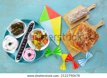 Colorful kite and fasting food for Clean Monday on turqoiuse table Royalty-Free Stock Photo #2122790678
