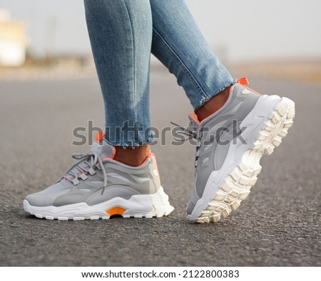 A man wearing sport sneakers on street . Men's sports shoes
 Royalty-Free Stock Photo #2122800383