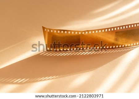 Gold film strips on beige background. Horizontal media theme poster, greeting cards, headers, website and app