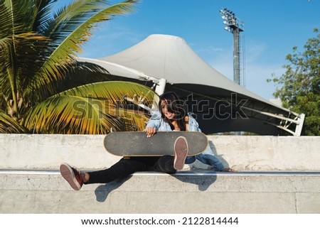 skater girl on ramp posing relaxed and sticking out her tongue