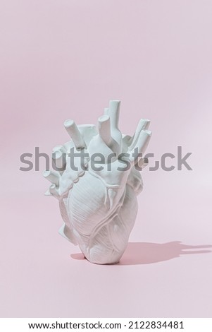 Sculpture Heart on a pink background. Creative Love, Valentine's day concept. Royalty-Free Stock Photo #2122834481