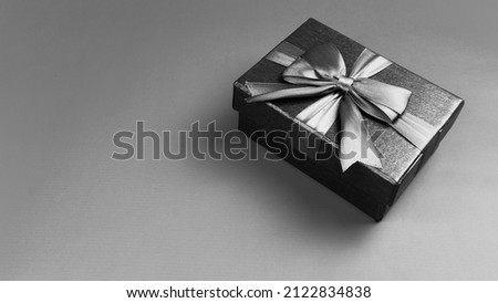 Valentine concept. Black and white, Gift box with ribbon on the table. Christmas and new year concept. Space for text. copy space. negative space.