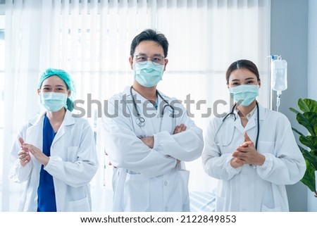 Portrait Group of Asian doctor and nurse clapping the hands with smile. Professional medical team stand in hospital office ward and giving encouragement to patient people after work in recovery room. Royalty-Free Stock Photo #2122849853