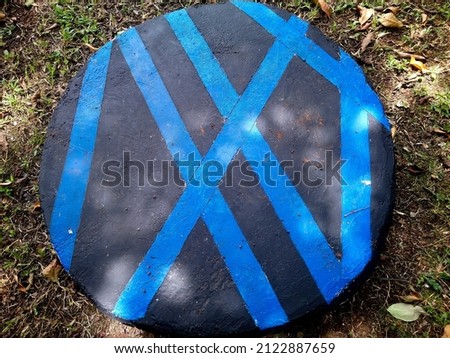 black cobblestones painted with blue abstract lines