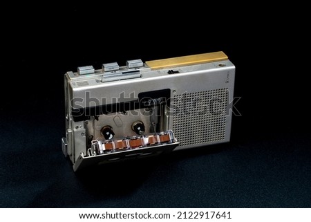 old micro tape recorder.Vintage Professional journalist tool. An audio cassette recorder was created in the 90s. soft focus. Royalty-Free Stock Photo #2122917641