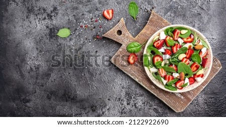 Diet menu. Healthy salad of fresh strawberry, spinach leaves, nuts and feta cheese, balsamic vinegar. Vegan food. Long banner format. top view.