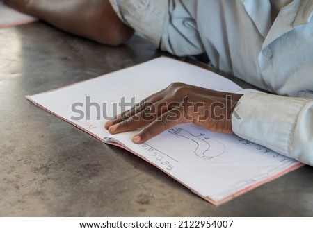 Primary school African student at his desk in the classroom
