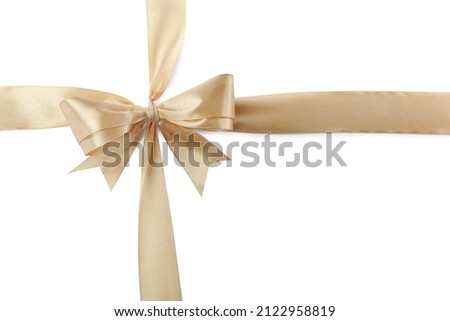 Golden satin ribbons with bow on white background, top view