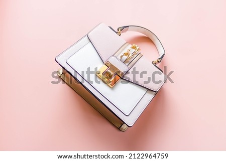 Luxury pink tone handbag on a light pink background.