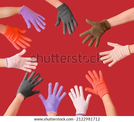 Women in warm gloves on color background