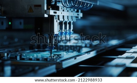 Automatic Pick and Place machine quickly installs Components on Circuit Board. Electronics and Circuit board Manufacturing. Dark Environment Royalty-Free Stock Photo #2122988933