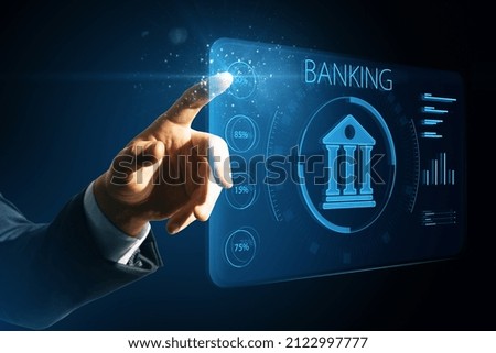 Man hand pointing at creative online banking hologram on blue blurry background. AI and automation concept. Double exposure Royalty-Free Stock Photo #2122997777