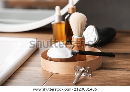 Stylish male accessories for shaving on table in bathroom Royalty-Free Stock Photo #2123031485