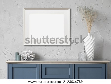 Horizontal picture frame mockup on a wall. Artwork template in interior design. Royalty-Free Stock Photo #2123036789