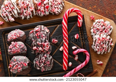 Wooden boards with tasty candy cane cookies on table