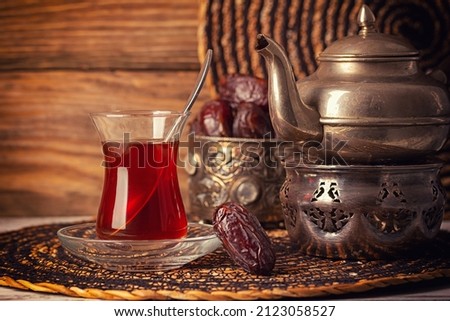 Black tea in armudu glass on wooden background