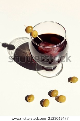 still life of a glass and olives
