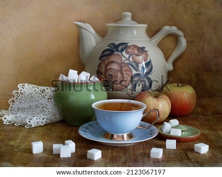 Still life with a cup of tea and a kettle.Cozy atmosphere of the kitchen. Royalty-Free Stock Photo #2123067197