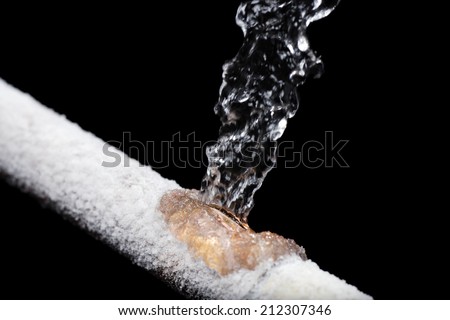A pipe leaking with Freeze damage Royalty-Free Stock Photo #212307346