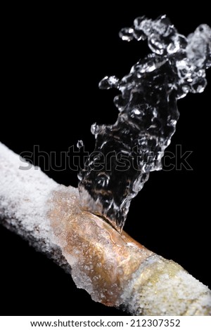 A pipe leaking with freeze damage Royalty-Free Stock Photo #212307352
