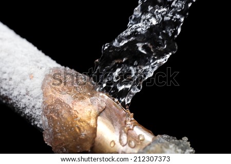A pipe leaking with freeze damage Royalty-Free Stock Photo #212307373