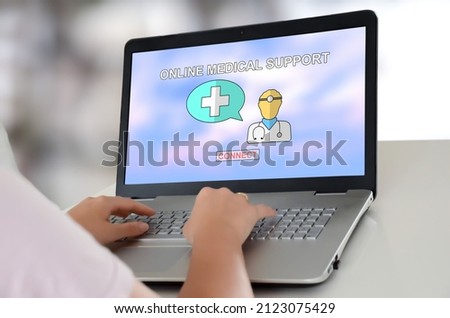 Woman using a laptop with online medical support concept on the screen