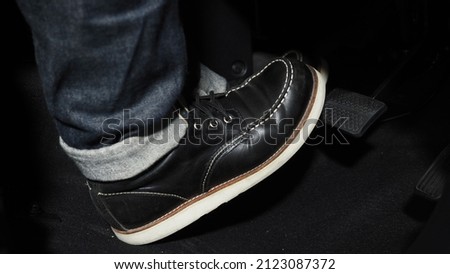 Accelerate and Brake. Foot pressing foot pedal of a car to drive ahead. Accelerator and brake pedal in a car. Driver driving the car by pushing accelerator pedals of the car. inside vehicle automobile Royalty-Free Stock Photo #2123087372