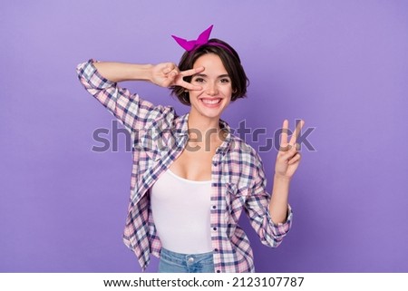 Photo of pretty cute woman wear plaid shirt showing two v-sign cover eyes isolated violet color background