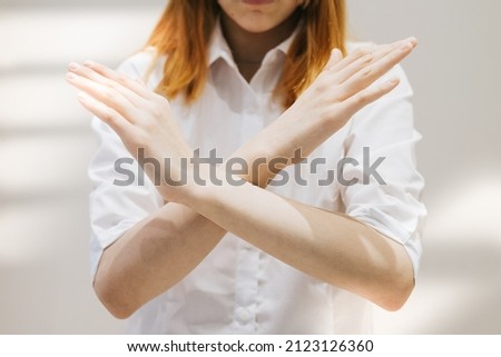 teenage girl generation Z with her arms crossed at her chest demonstrates Break The Bias symbol of international women's day principles of feminism, gender equality and support Royalty-Free Stock Photo #2123126360