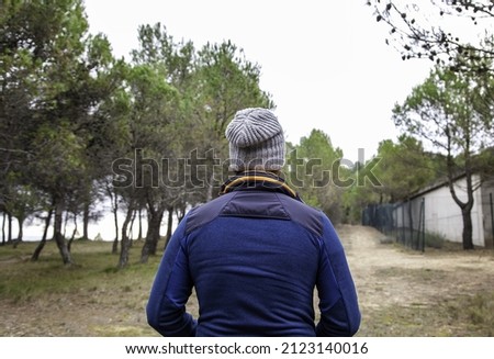 Hooded person in forest with problems, youth and crisis