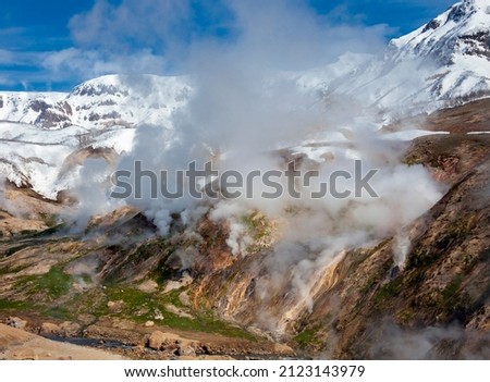 Geyser landscape with emissions of boiling water, steam and gases in the Valley of Geysers. Columns of smoke and steam from the eruption of geysers in the Kamchatka valley of Geysers.   Royalty-Free Stock Photo #2123143979