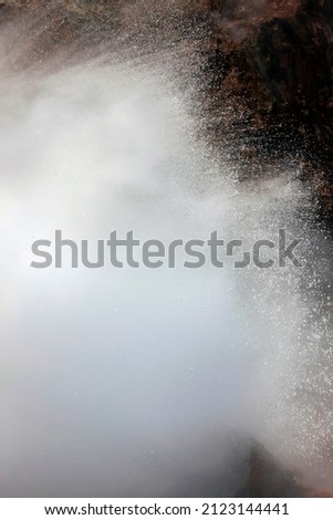 Emissions of boiling water, steam and gases from thermal geysers close-up. Splashes and drops of water from a geyser eruption in the Kamchatka valley of Geysers.  Royalty-Free Stock Photo #2123144441