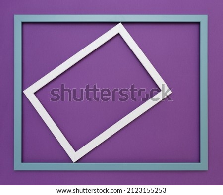 White frame rotated in a light blue frame on a dark purple background