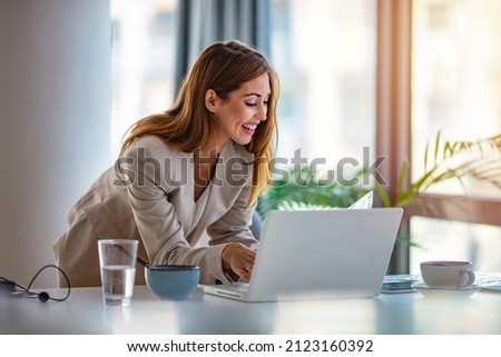 Beautiful clever cute charming attractive elegant owner of big company has online meeting with international business partners, she is sitting at the table at workstation
