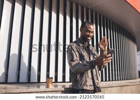 African American man enjoying vacations travel shooting content vlog for sharing media to social networks, cheerful dark skinned male making online video calling using roaming internet connection