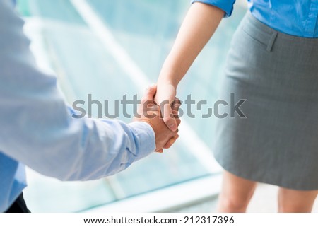 Close-up of businesspeople shaking hands Royalty-Free Stock Photo #212317396