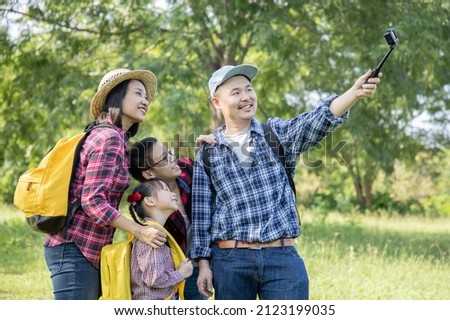 Family on hike in a forest taking selfie group portrait,Travel vacations and life concept.