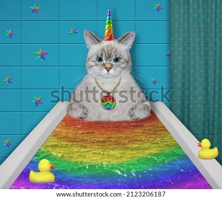 An ashen caticorn takes a rainbow bath.
