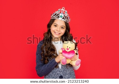 happy child in queen crown. princess in tiara. kid holding bear toy. teen girl wear diadem