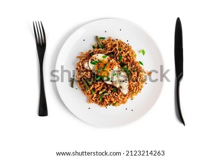 Hot fresh noodles with fried egg isolated on a white background. High quality photo