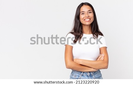 pretty thin hispanic woman looking like a happy, proud and satisfied Royalty-Free Stock Photo #2123220920