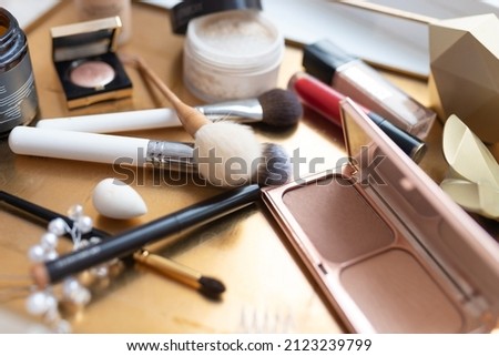 Cosmetics and makeup brushes, on the table. High quality photo
