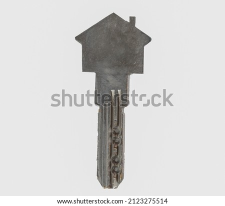 Close up photo of house shaped key on isolated background.  