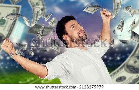 Happy man for winning a sport bet. Rain of money inside a soccer stadium background