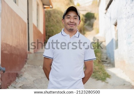 Latin man smiling outside his house in rural area - Hispanic man proud of his roots Royalty-Free Stock Photo #2123280500
