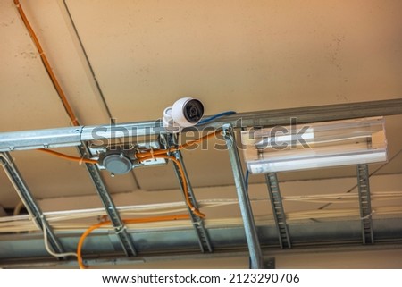 Close up view of modern surveillance safety camera under ceiling . Security concept. Sweden. 