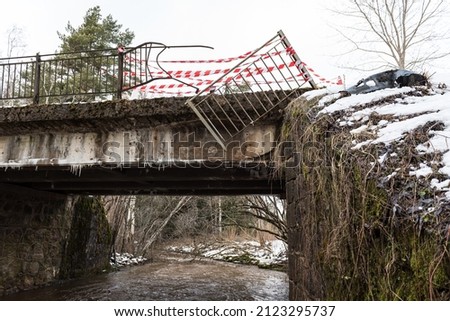 A car accident hit a bridge railing in snowy winter day. White and red ribbon.