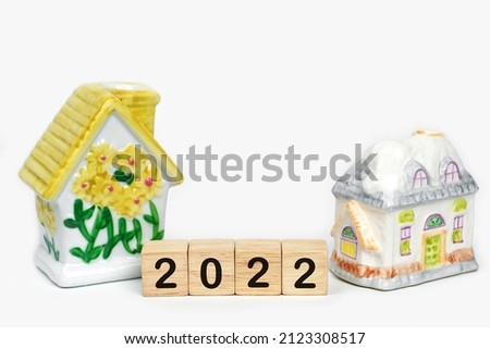 New House 2022 on, house model on 2022 wooden blocks number. New year property investment concept.             