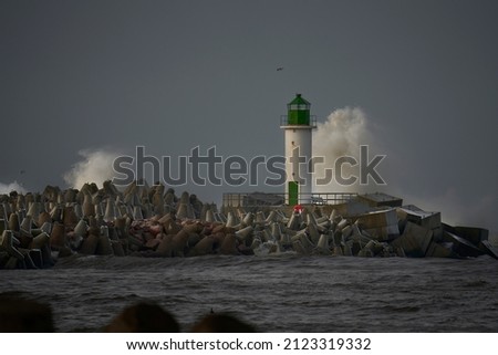 Waves crashing over a lighthouse Royalty-Free Stock Photo #2123319332