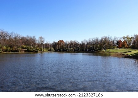 The beautiful peaceful view of the lake on a bright sunny autumn day.